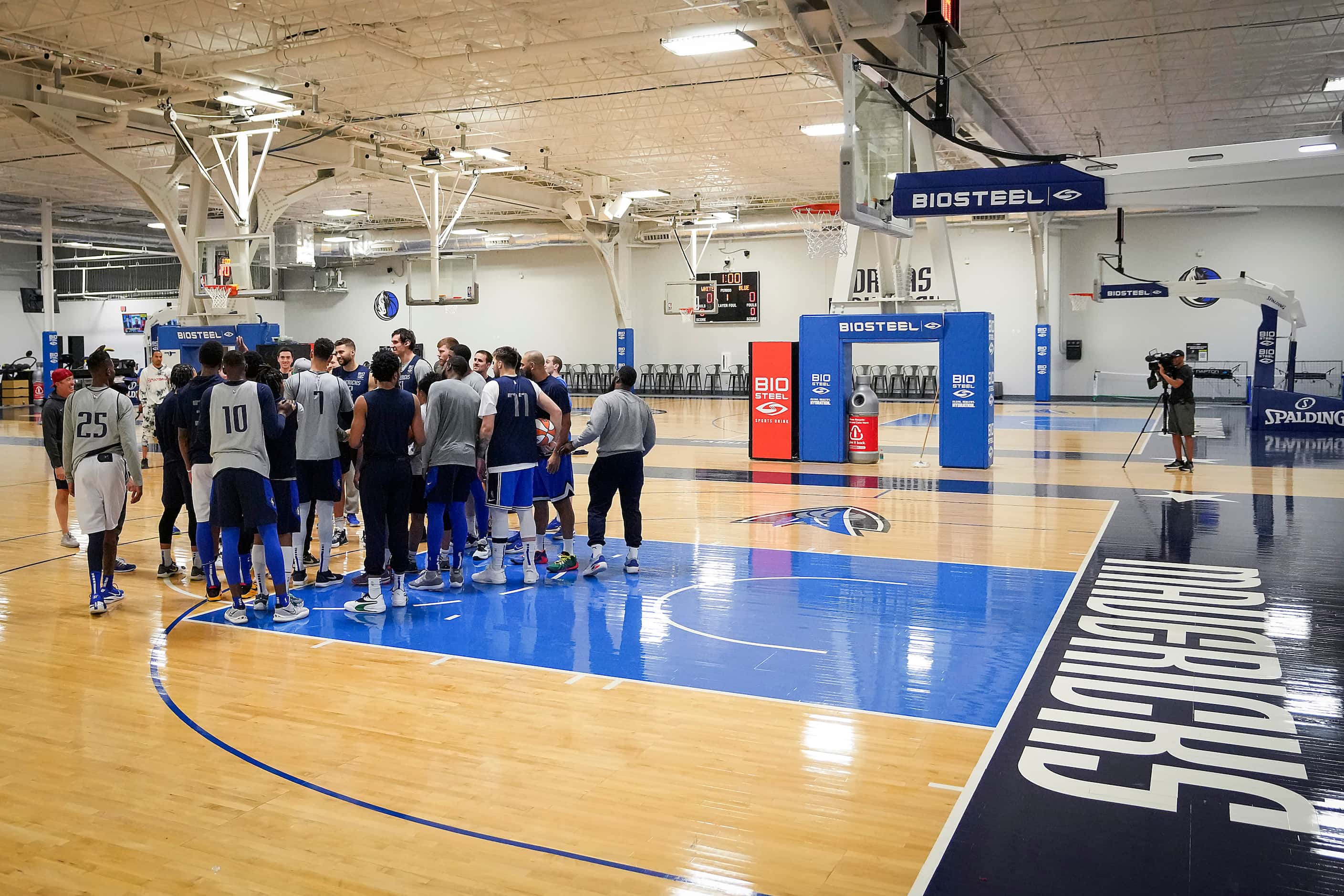 Dallas Mavericks players and coaches huddle as the team practices in preparation for Game 3...