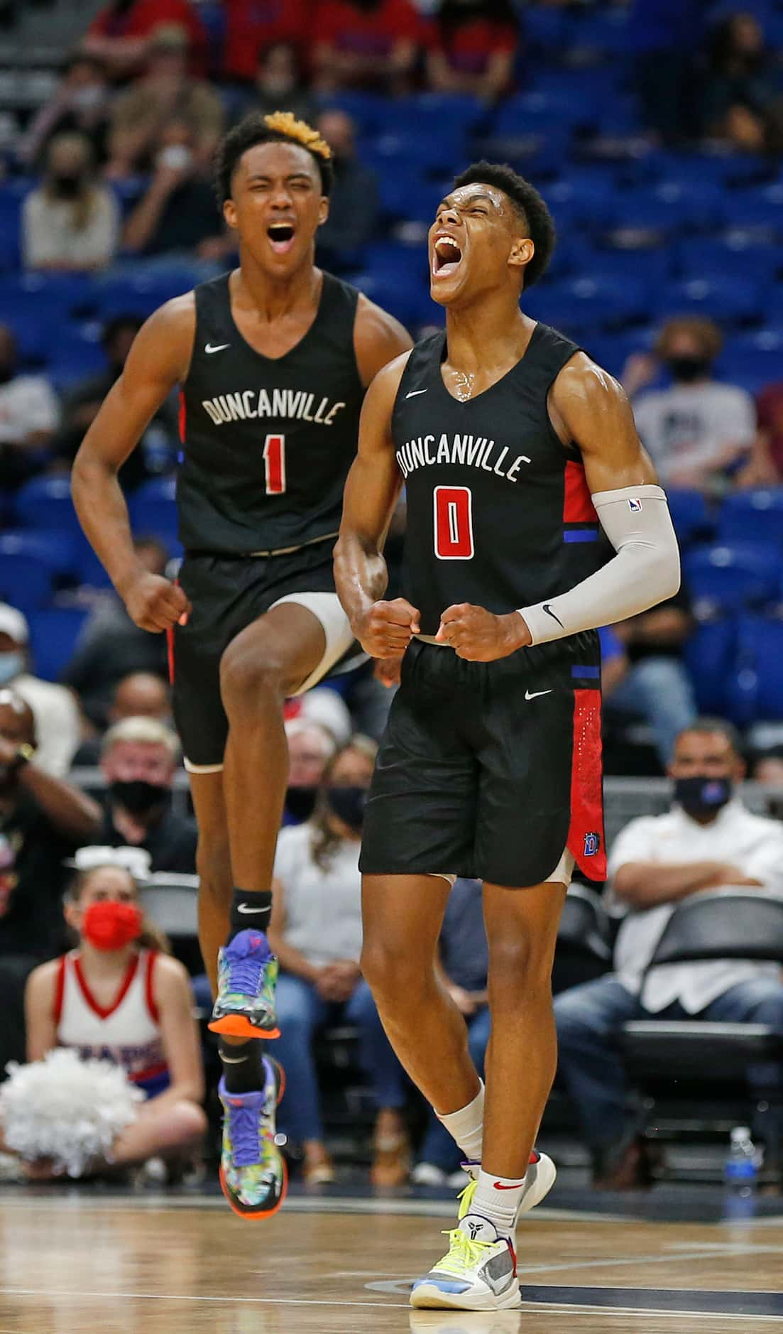 Duncanville Zhuric Phelps #0 and Duncanville Ron Holland #1 begin to celebrate in closing...