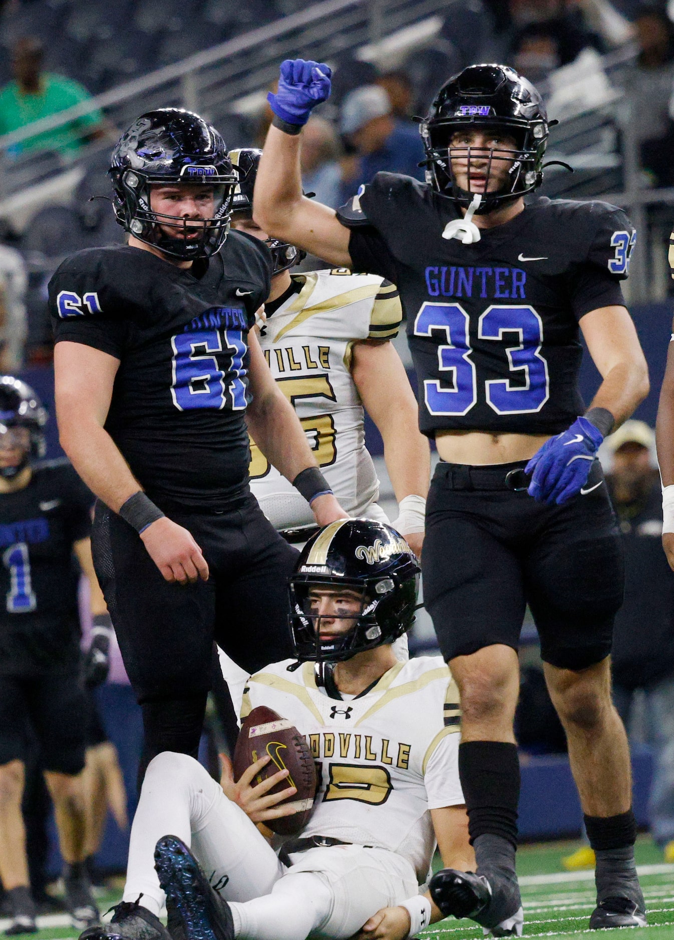 Gunter's  Hayden Farrell (33) celebrates with his teammate Garrin Goetz (61) after sacked...