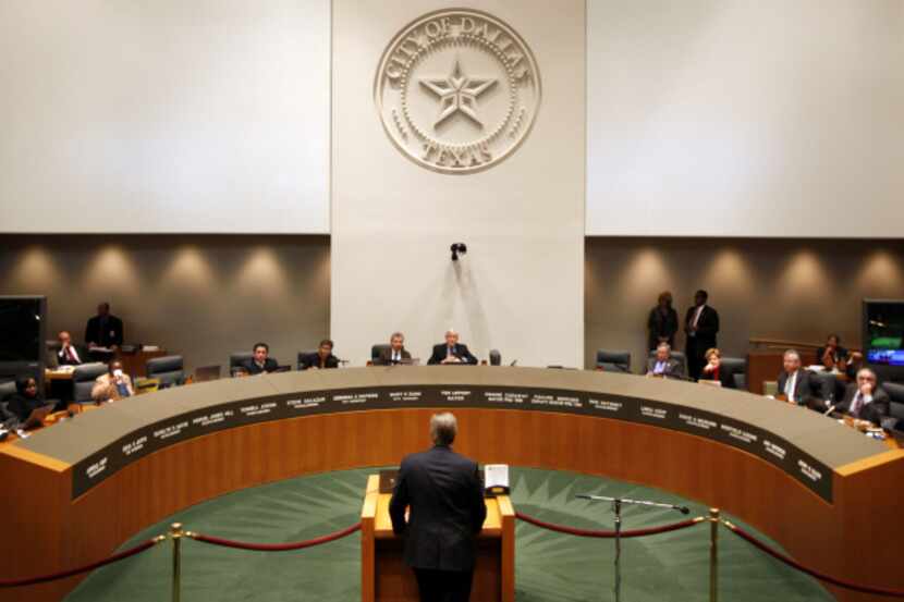 The Dallas City Council hears from a speaker during a meeting in council chambers. Federal...