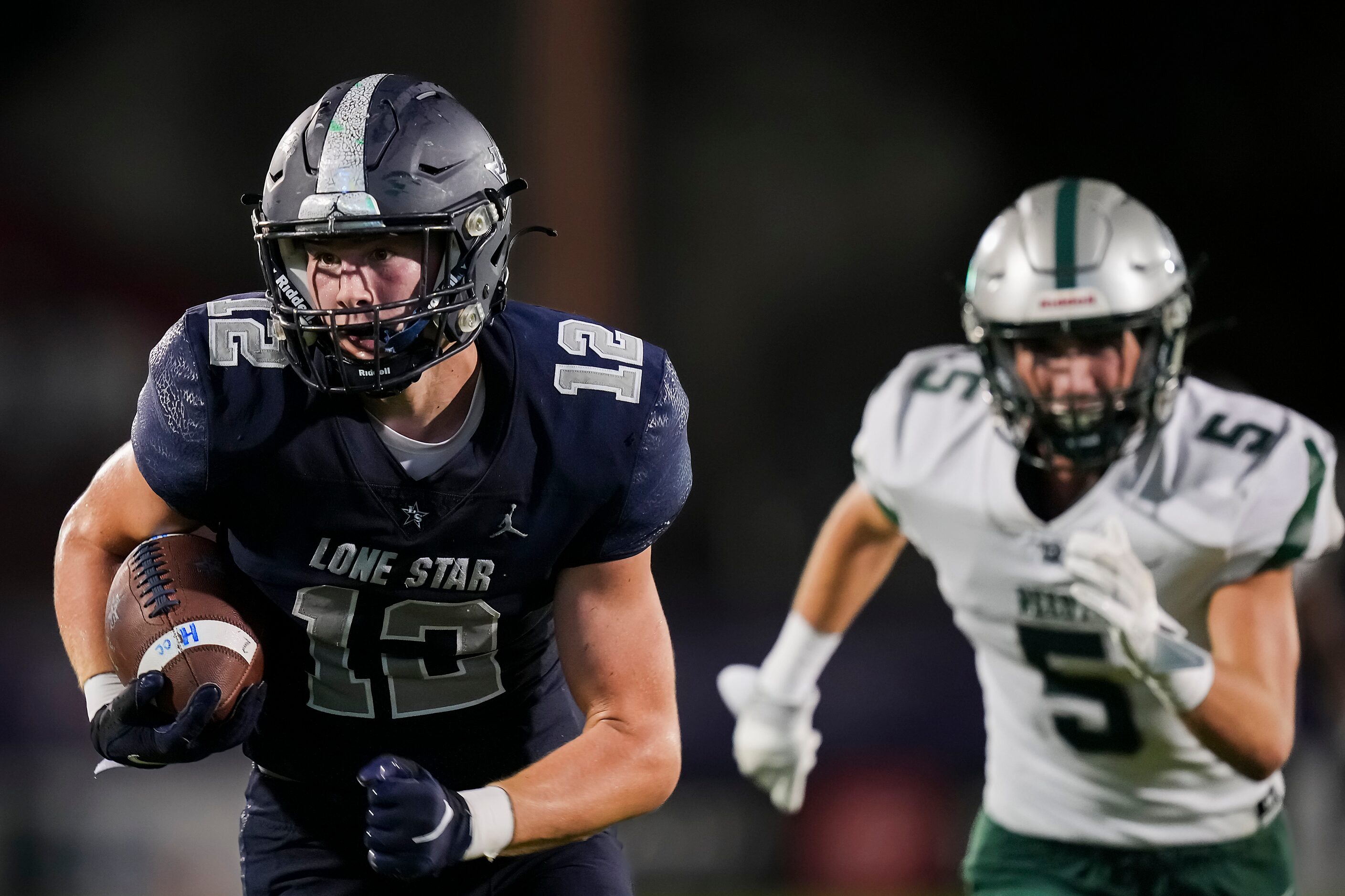 Frisco Lone Star’s Ryder Mix (12) races for the end zone past Frisco Reedy’s Cooper Clabo...