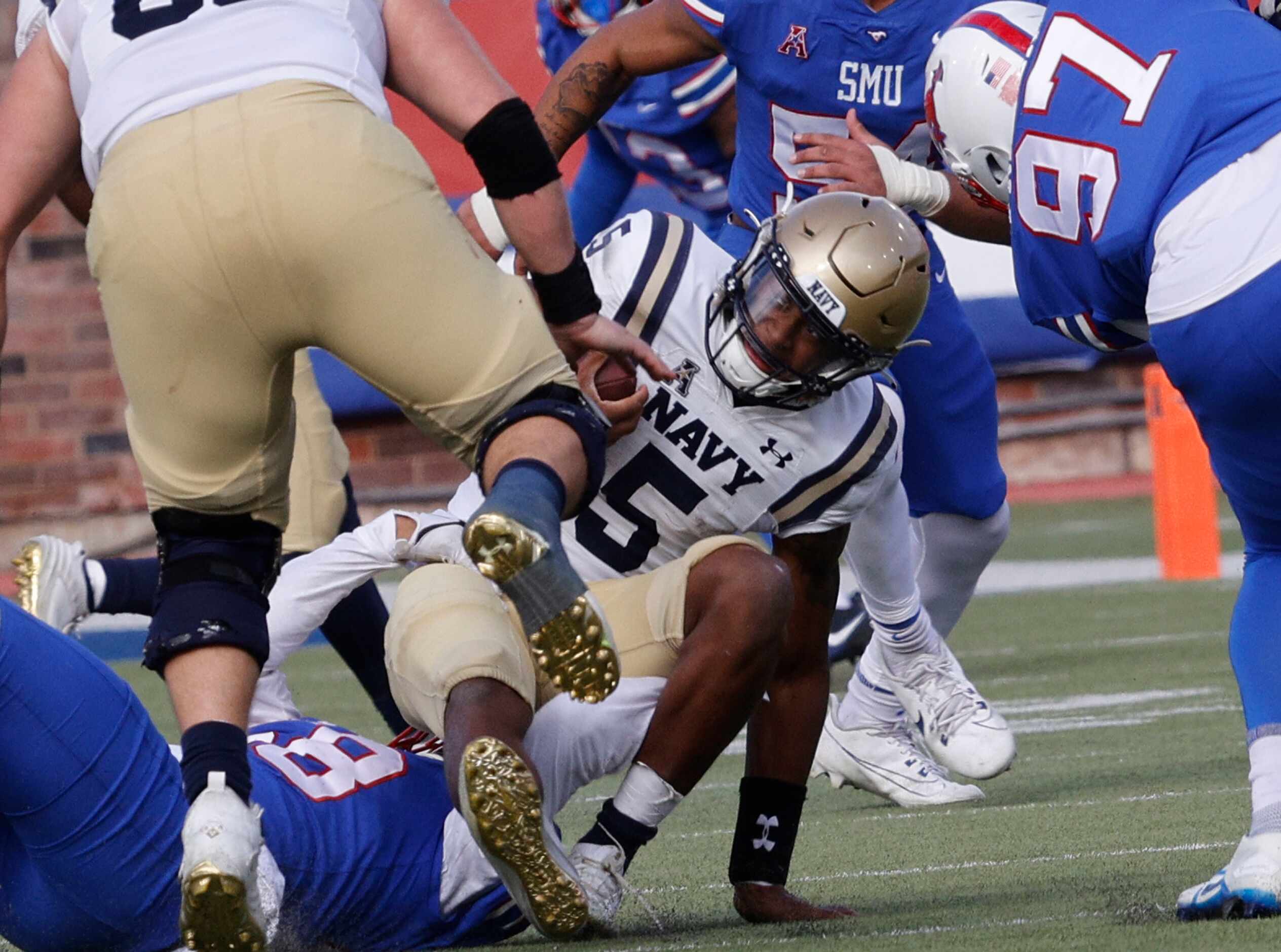 Navy quarterback Braxton Woodson (5) is sacked by SMU defensive end Isaiah Smith (58),...