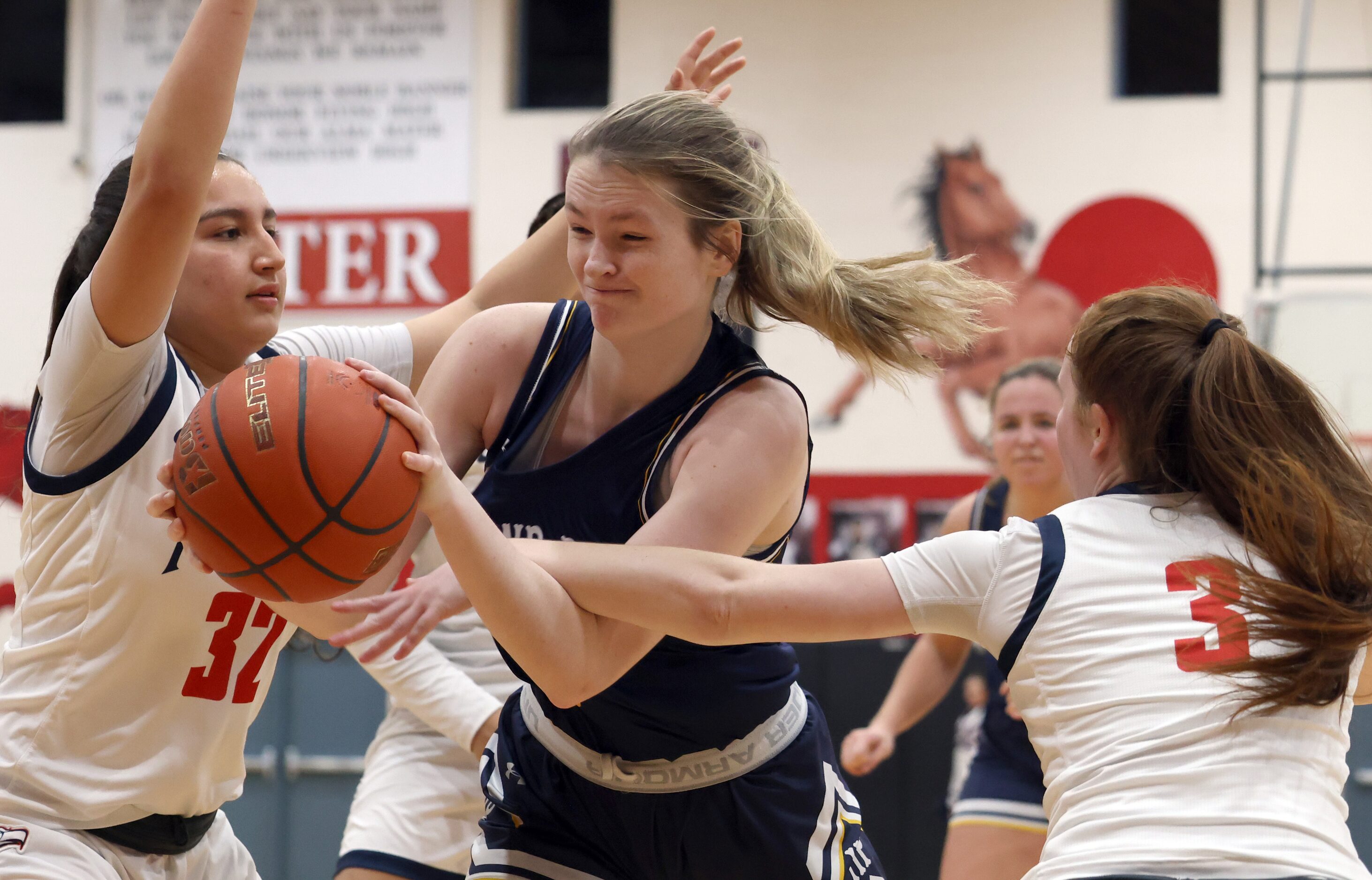 Highland Park forward Kate Danner (5), center, drives between the defense of Allen defenders...