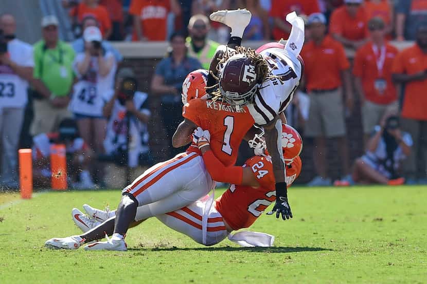 FILE - Texas A&M wide receiver Kendrick Rogers (top) is tackled by Clemson cornerback Derion...