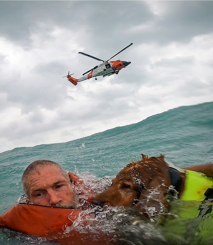 This photo provided by U.S. Coast Guard District Seven (USCGSoutheast) shows a man and his...