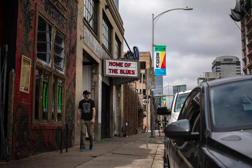 A man walks past Antone's, one of many South by Southwest venues where official festival...