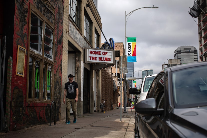 A man walks past Antone's, one of many South by Southwest venues where official festival...