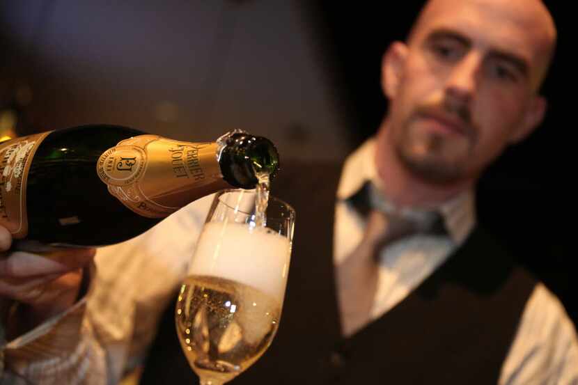 Pablo Taboada pours champagne at Max's Wine Dive in Dallas November 13, 2012. (Nathan...