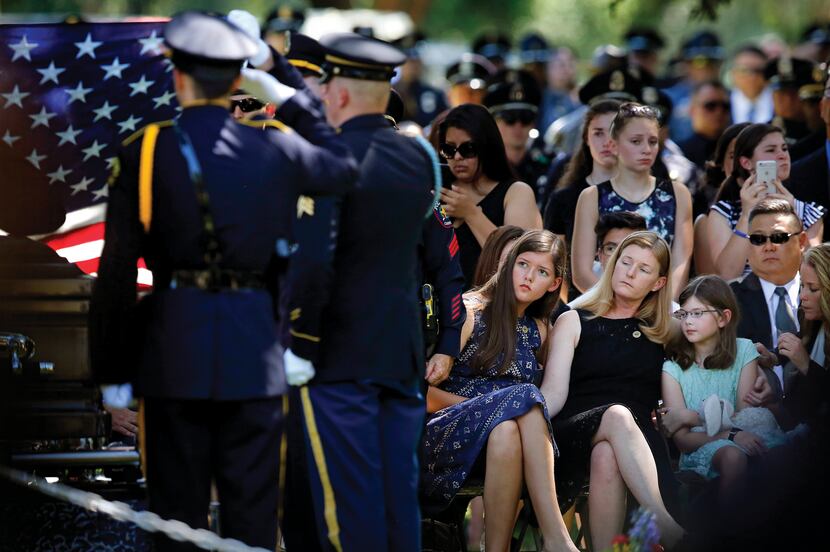 Heidi Smith and her daughters Victoria and Caroline were graveside as they laid her husband,...