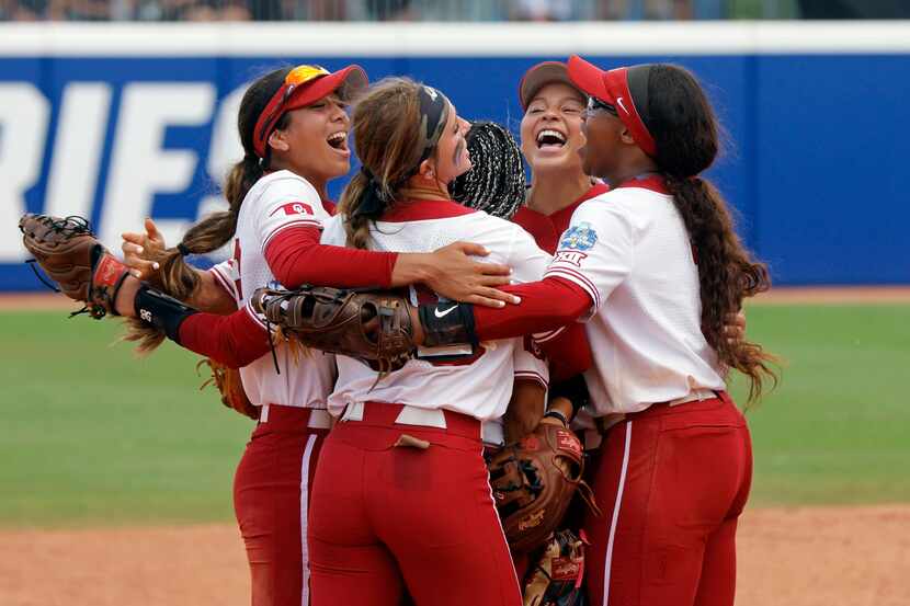 Oklahoma players celebrate a win over Stanford in an NCAA softball Women's College World...