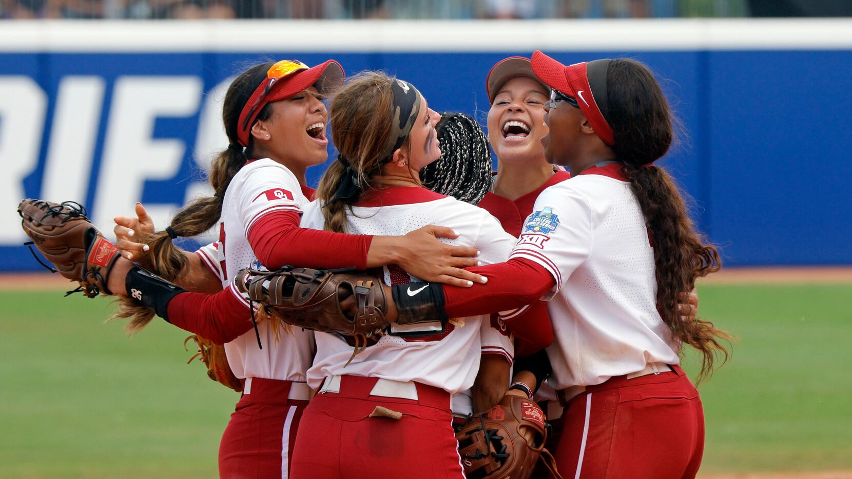Oklahoma players celebrate a win over Stanford in an NCAA softball Women's College World...