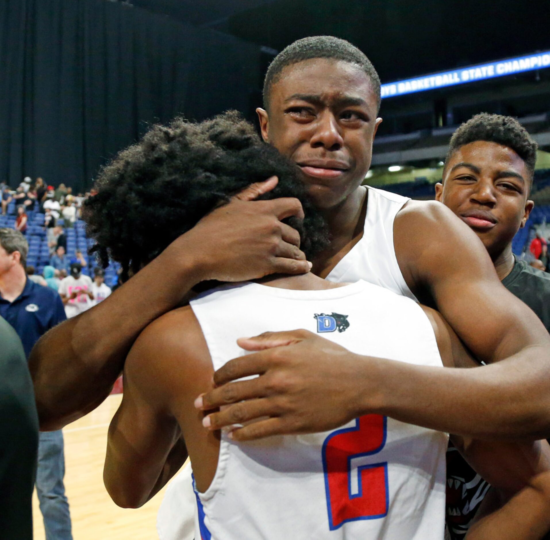 Duncanville's Ja'Bryant Hill #2 hugs Duncanville's Keyaun Hoskin #1 following a UIL boys...