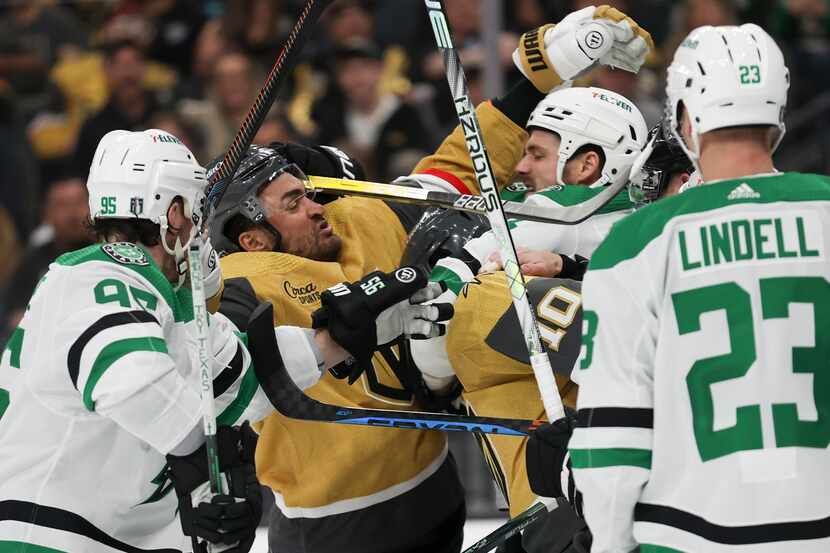 Vegas Golden Knights left wing William Carrier (28) and center Nicolas Roy (10) fight Dallas...