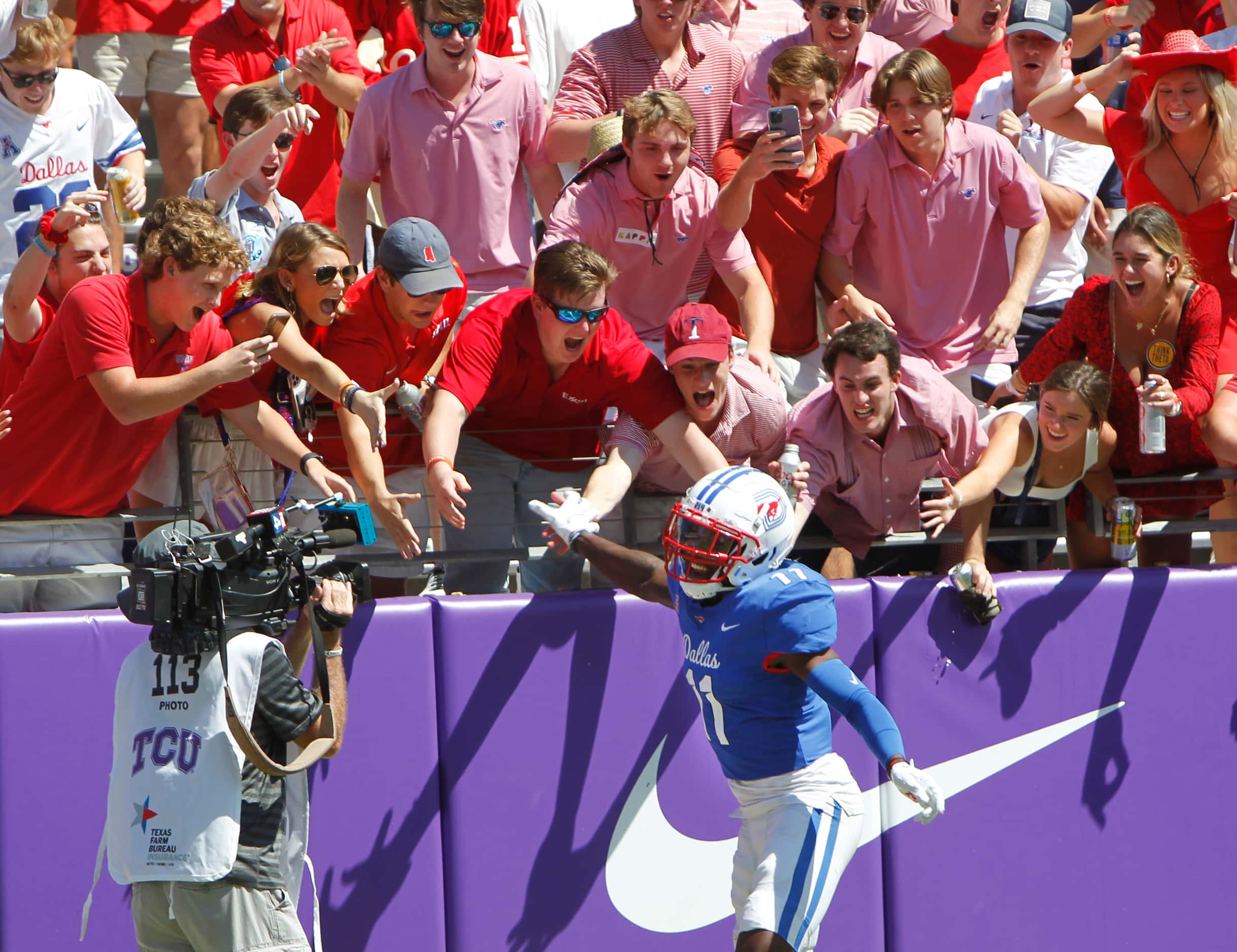 SMU receiver Rashee Rice (11) celebrates with Mustangs fans in the end zone following his...