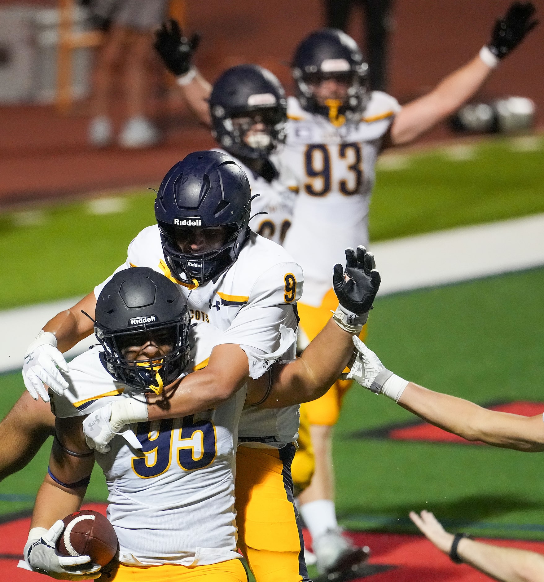 Highland Park defensive lineman Amin Elahmadi (95) celebrates with linebacker Jack Morse (9)...