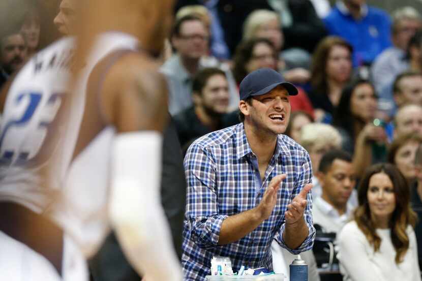 FILE - Tony Romo cheers on the Dallas Mavericks during the second half of play at American...