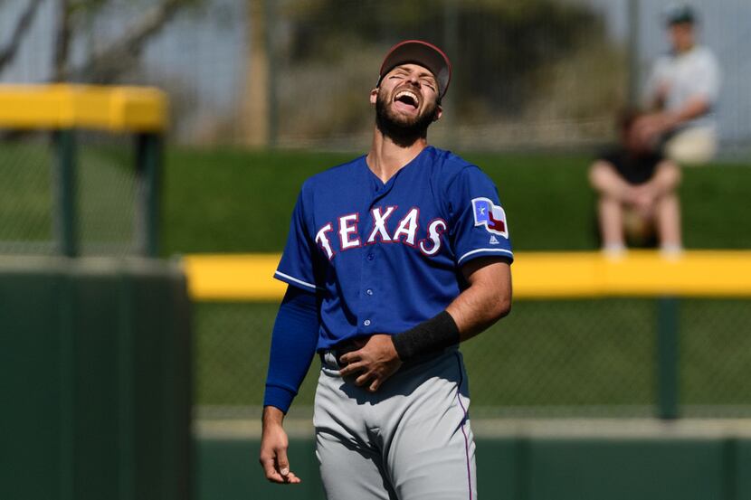 MESA, ARIZONA - MARCH 05: Joey Gallo #13 of the Texas Rangers laughs while warming up for...