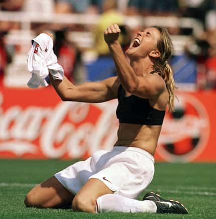 The United States' Brandi Chastain celebrates by taking off her jersey after scoring the...