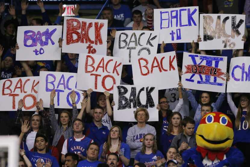 Kansas fans celebrate gaining a share of their tenth straight Big-12 championship during the...