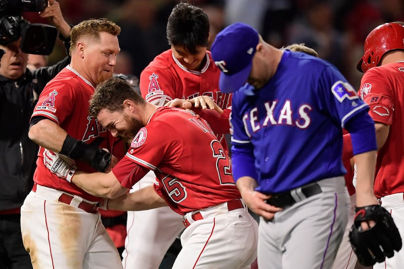 Los Angeles Angels' Jared Walsh, second from left, celebrates with Kole Calhoun, left, and...