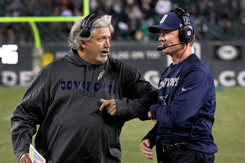 Dallas Cowboys defensive coordinator Rob Ryan elbows head coach Jason Garrett as they watch...
