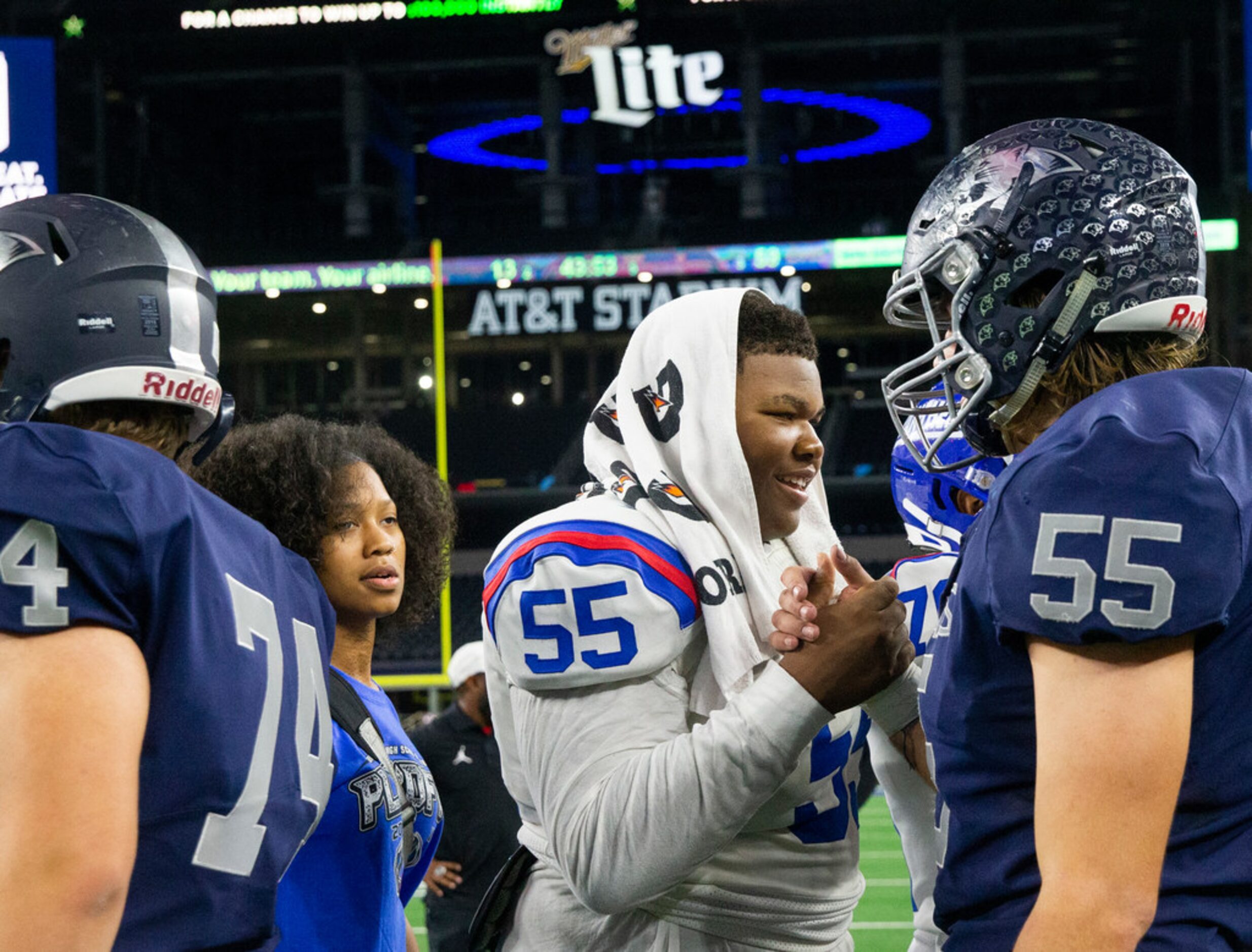 Duncanville offensive lineman Joshua Qualls (center, 55) greets Flower Mound defensive end...