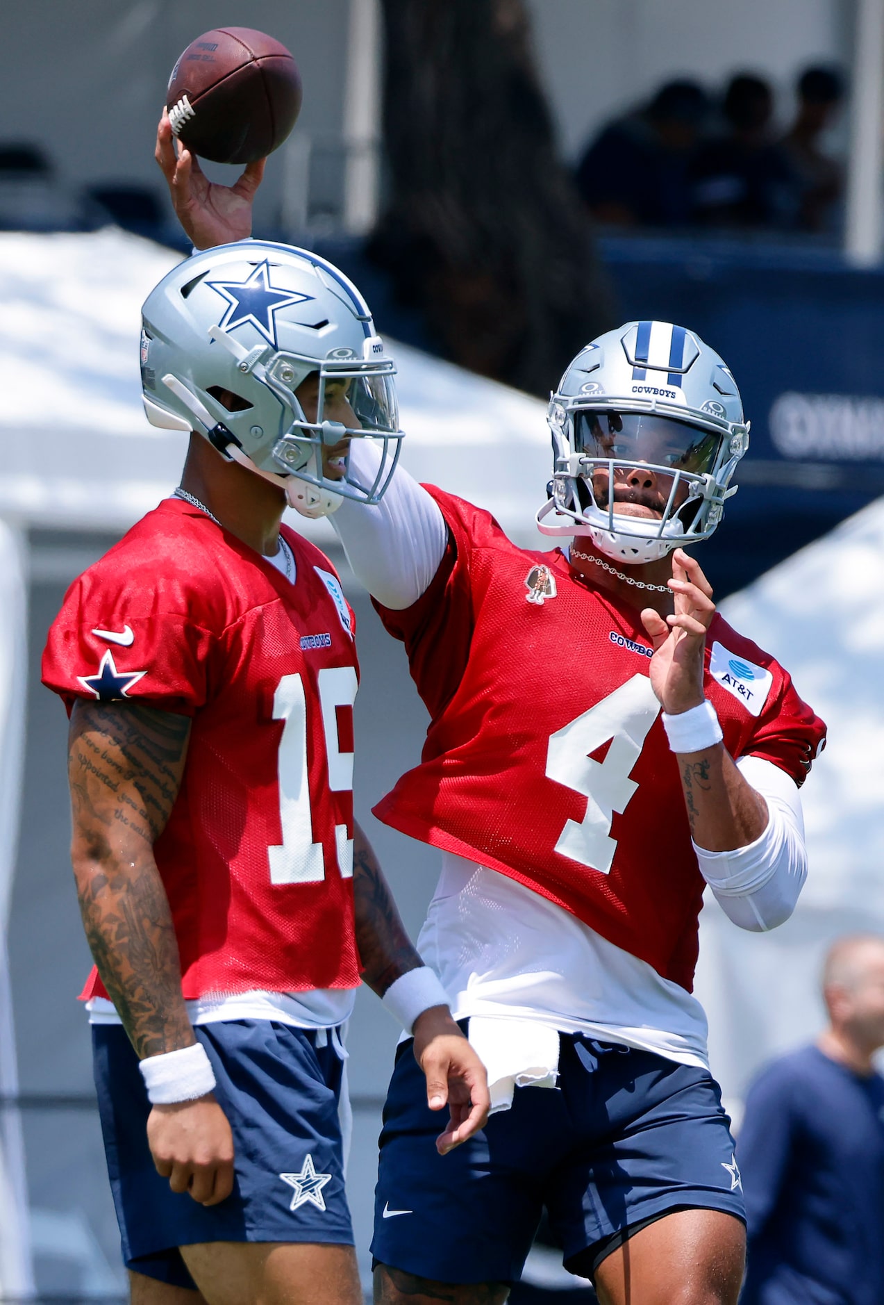 Dallas Cowboys quarterback Dak Prescott (4) throws a pass over fellow quarterback Trey Lance...