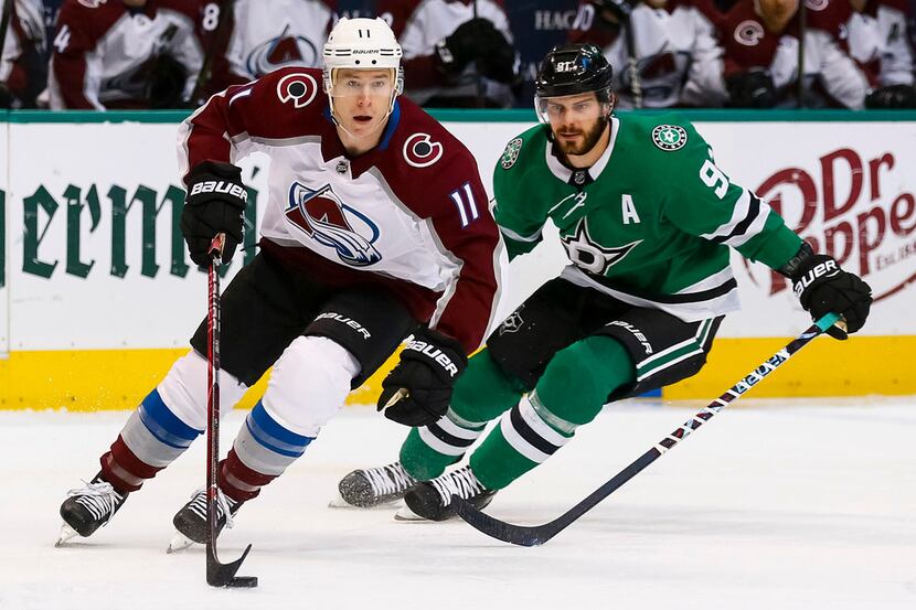 Colorado Avalanche left wing Matt Calvert (11) skates with the puck in front of Dallas Stars...
