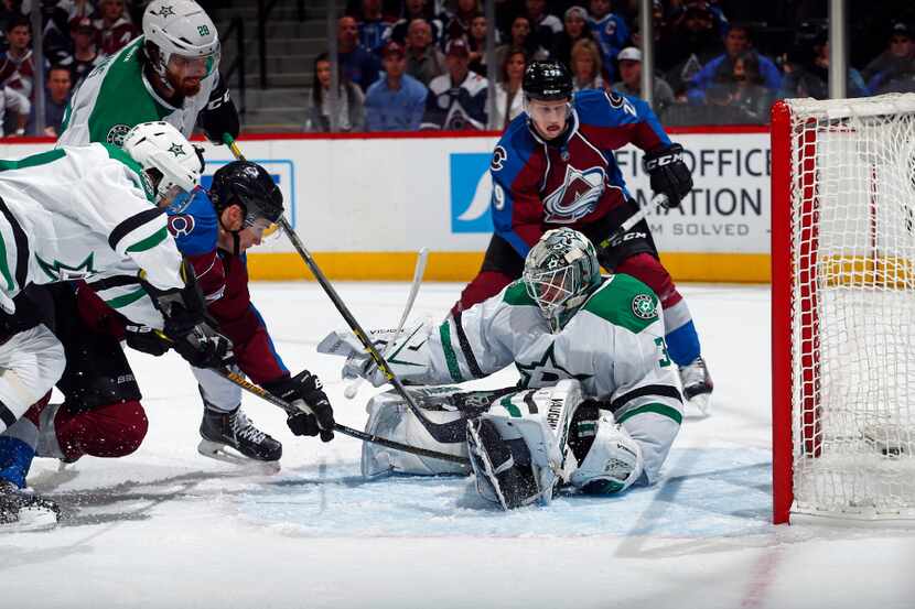 Dallas Stars' Johnny Oduya (47) and Stephen Johns (28) defend as Colorado Avalanche center...