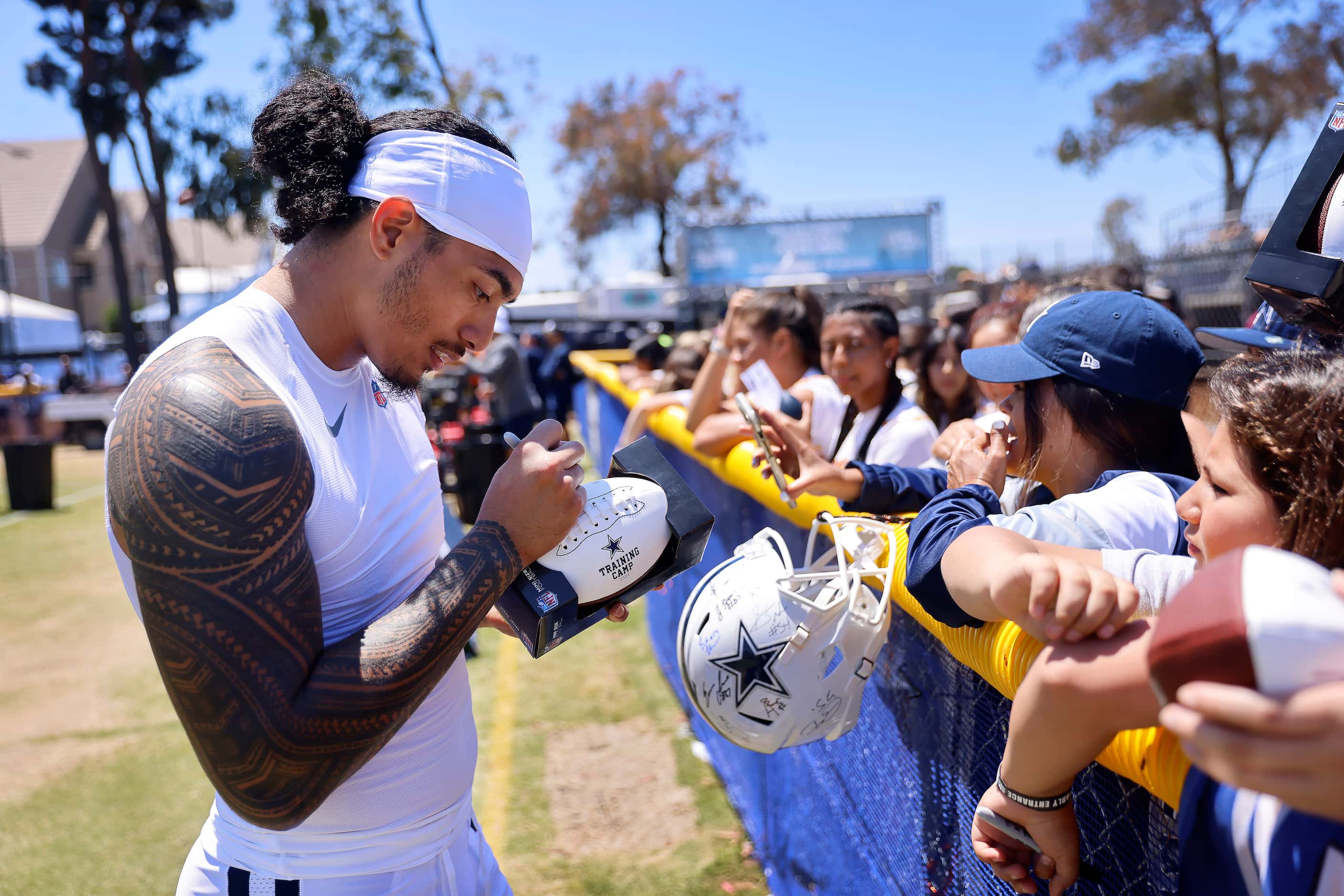 Dallas Cowboys rookie linebacker Marist Liufau signs autographs for fans following training...