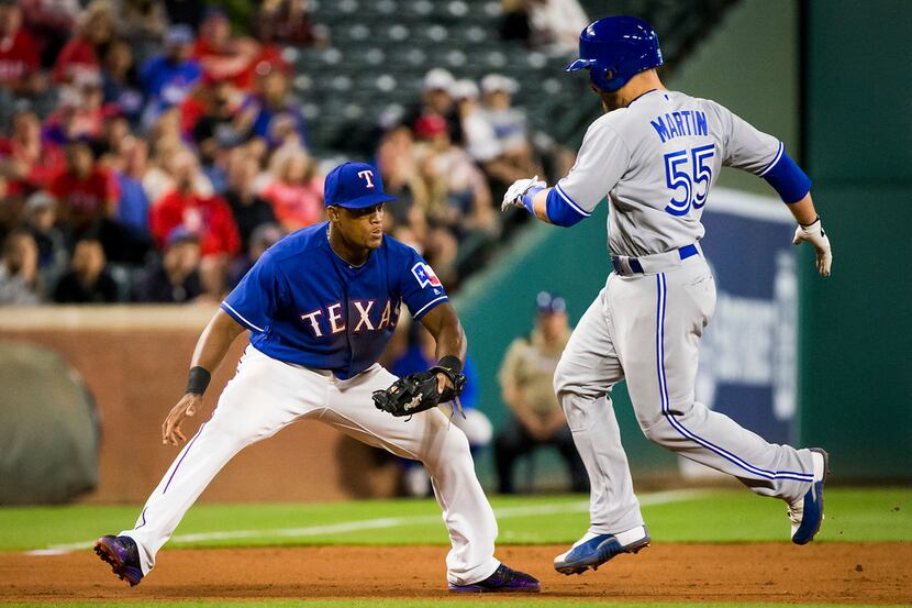 Texas Rangers third baseman Adrian Beltre applies the tag to Toronto Blue Jays catcher...