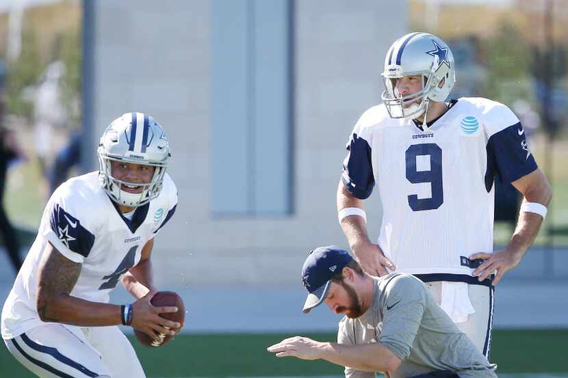 Dallas Cowboys quarterback Tony Romo (9) observes as quarterback Dak Prescott (4) runs a...