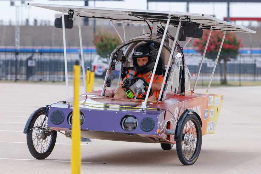 Teagan McGuire of Watertown High School performs a test drive of their solar car during this...