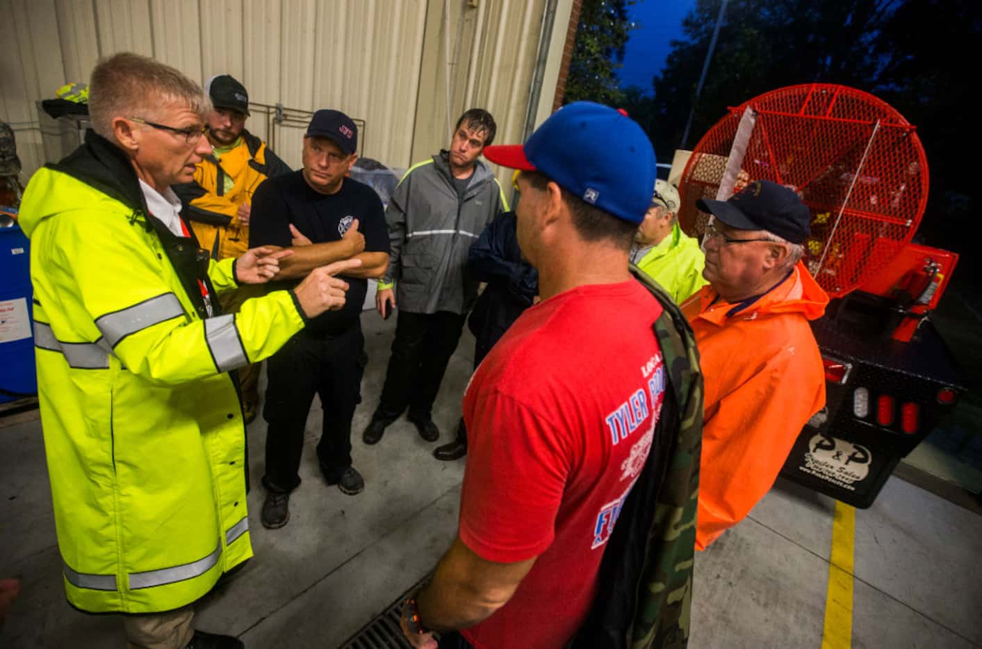 Fire Chief Jeff McNeal (left) directs volunteers at Lumberton Central Fire Station as...