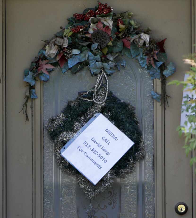 A notice on the door of a house listed as Eric Williams’ directs media to call David Sergi...