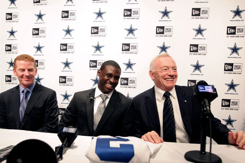 Dallas Cowboys owner Jerry Jones (right) laughs with head coach Jason Garrett (left) and...