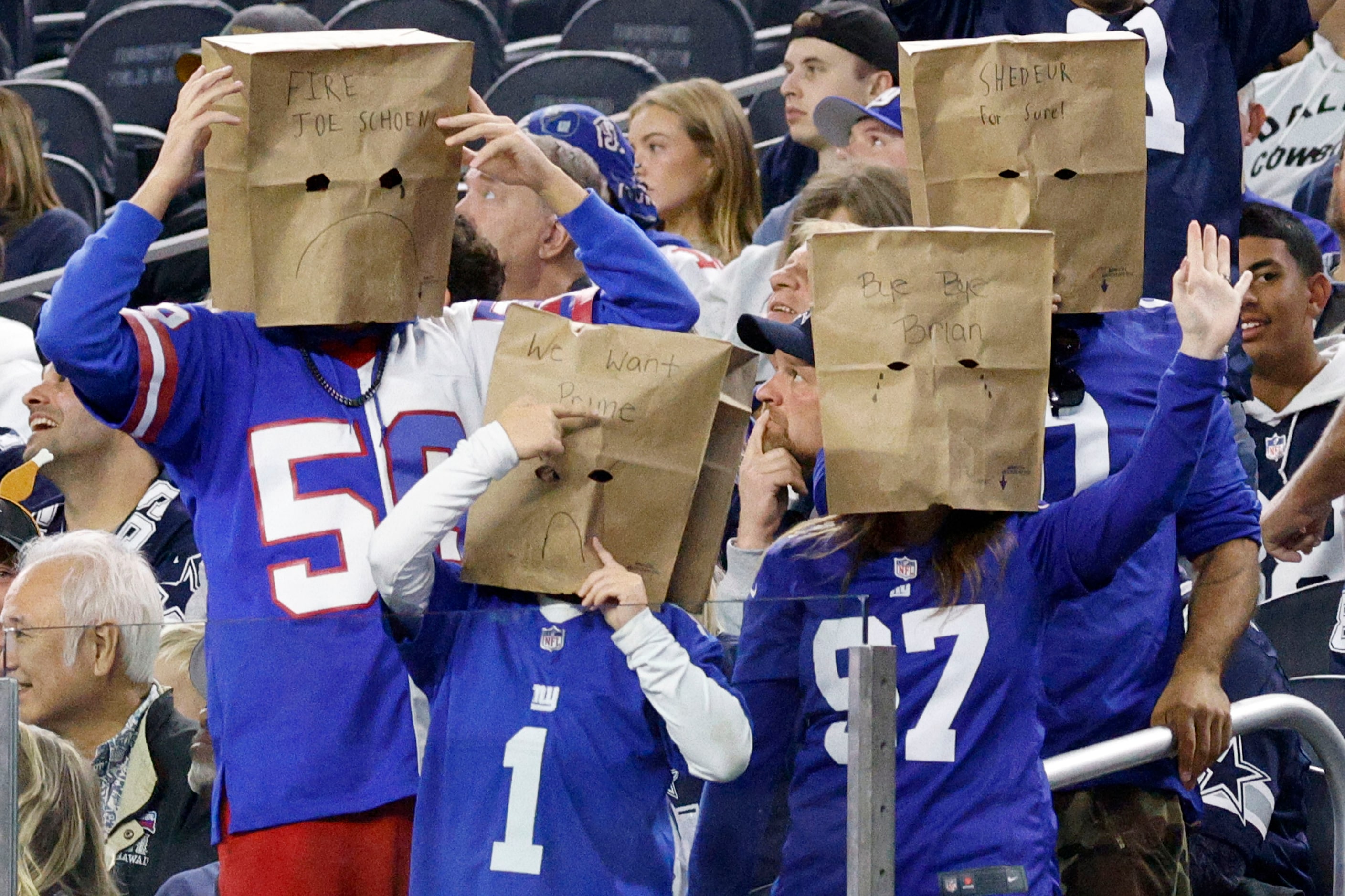 Fans show some messages in the second half of an NFL football game between the Dallas...