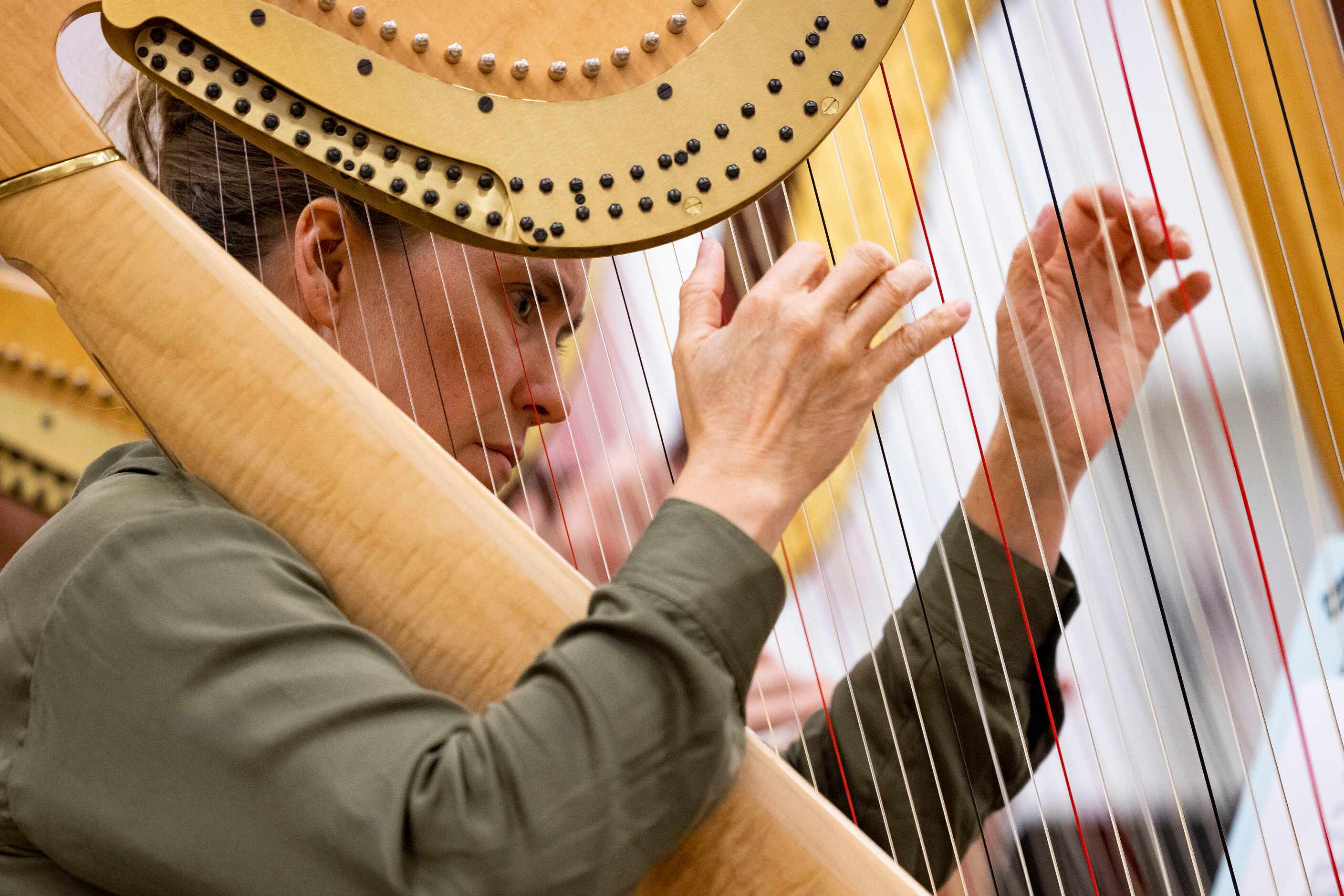 Jaymee Haefner, one of six harpists, performs during the orchestral rehearsal for Dallas...