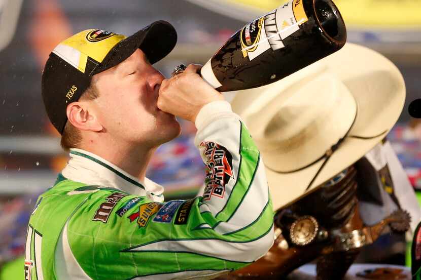 Kyle Busch drinks champagne after winning the Duck Commander 500 race at Texas Motor...