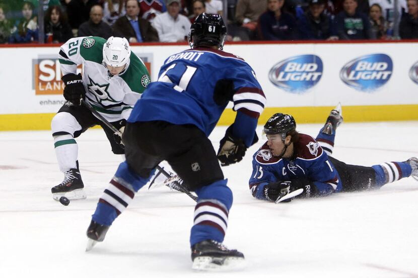 Oct 15, 2013; Denver, CO, USA; Dallas Stars center Cody Eakin (20) skates with the puck as...