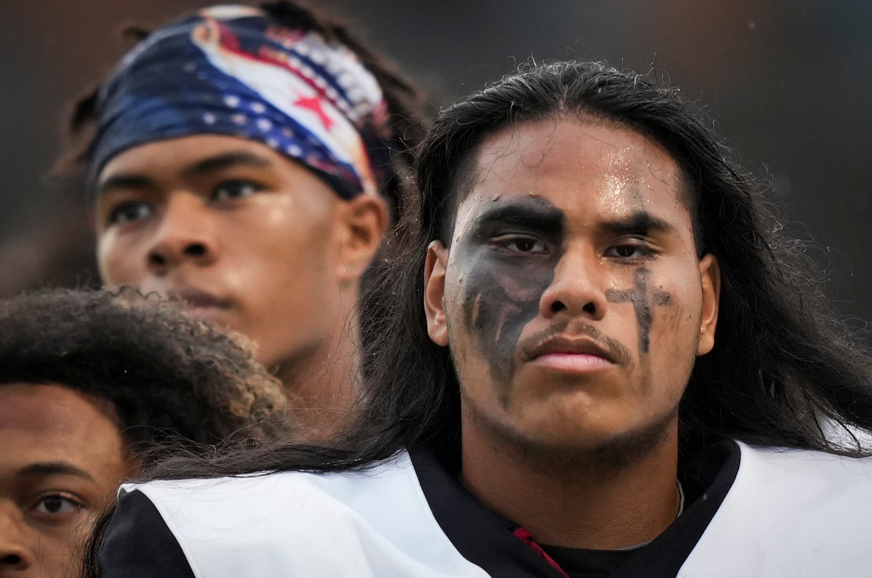 Euless Trinity offensive lineman Sio Lea'Aeatoa stands for the national anthem with his team...