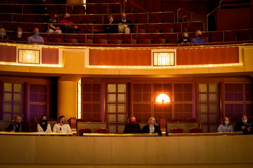 Socially distanced patrons listen as guest conductor Andrew Grams and pianist William...