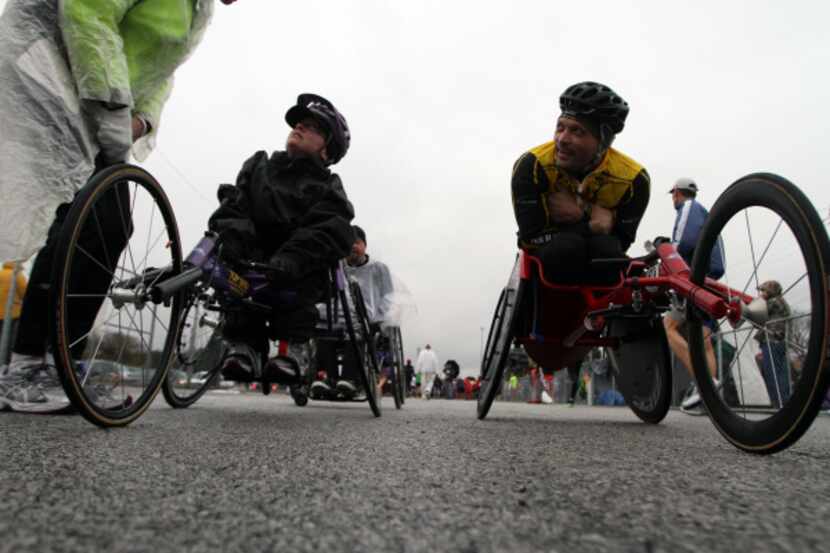 Wheel chair racers Courtney Washer, left, of Sherman and Justin Meaders, of Keller, wait for...