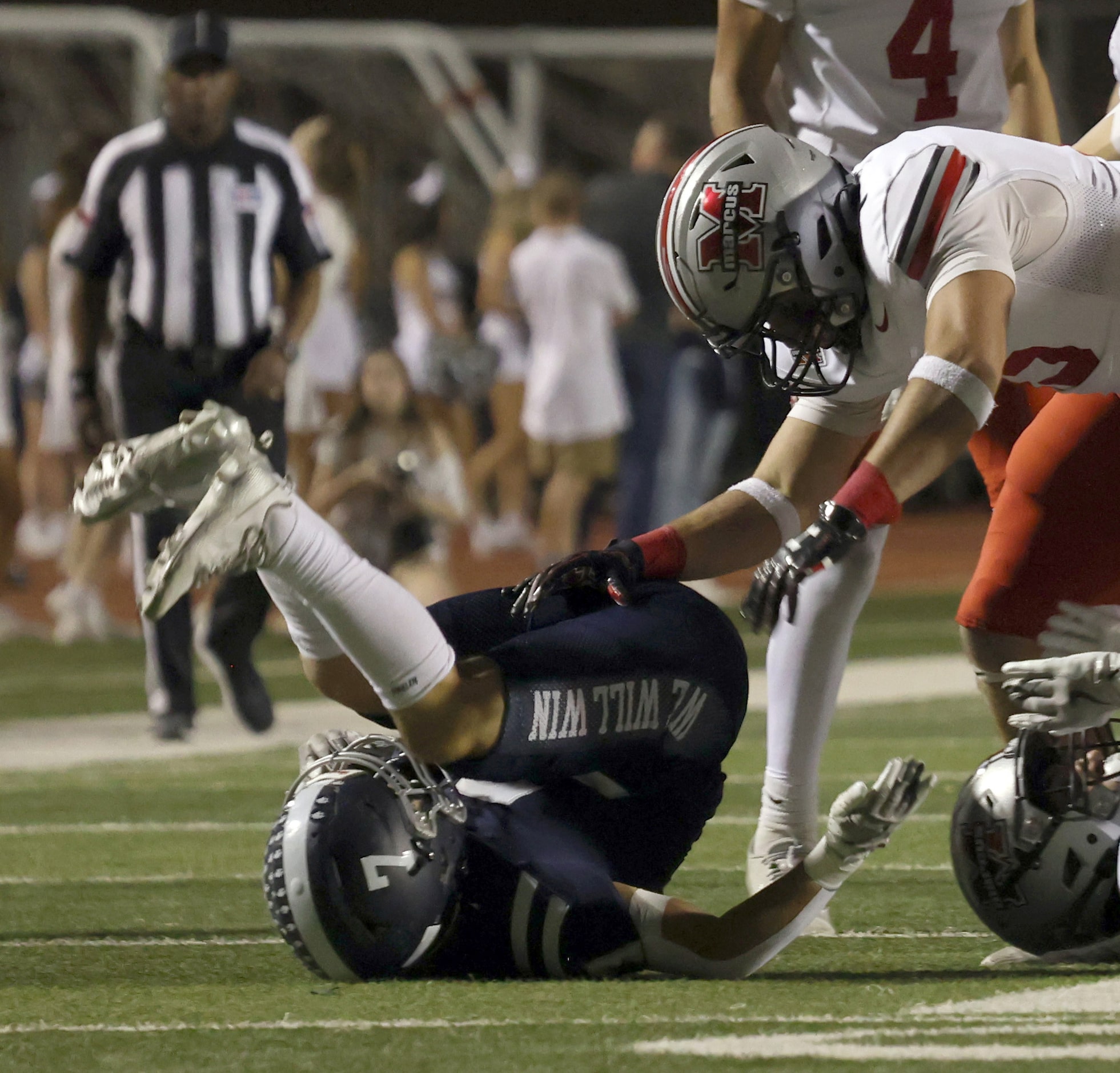 Flower Mound's Ryan Stadler (7) is dropped for a one yard loss after being pulled down...