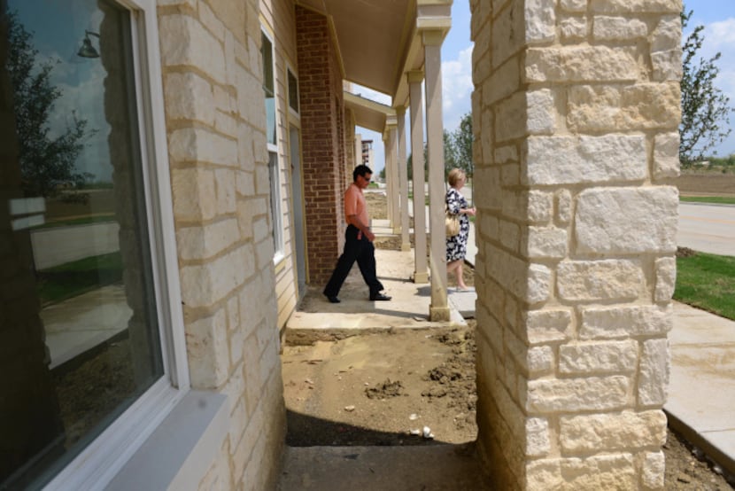 Coppell ISD assistant superintendent Sid Grant tours a multi-family apartment, which is part...