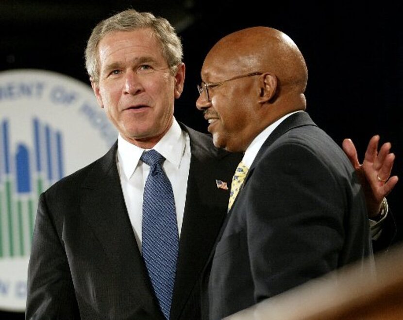 President George W. Bush embraced Alphonso Jackson before signing the American Dream...