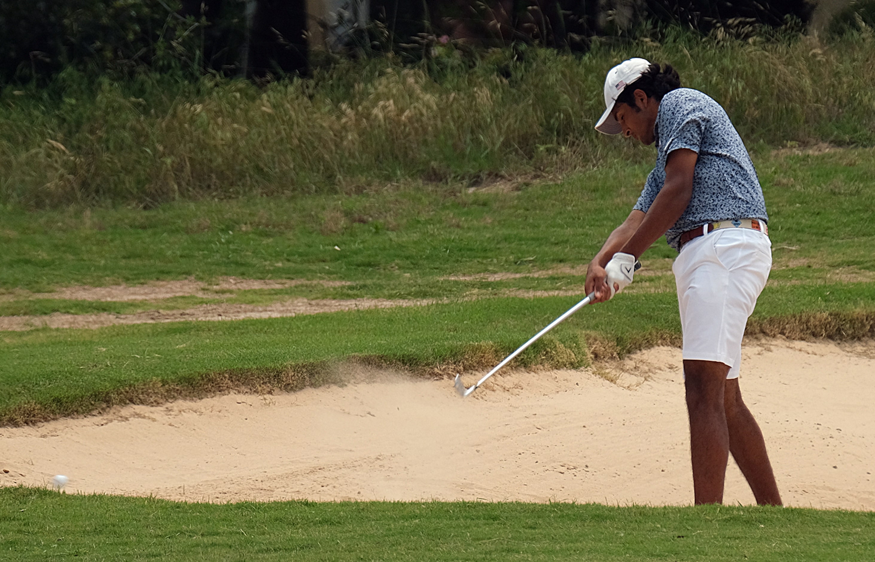 Rohan Shastry of Allen hits out of a sand trap Day 2 of the UIL 6A boys golf state...