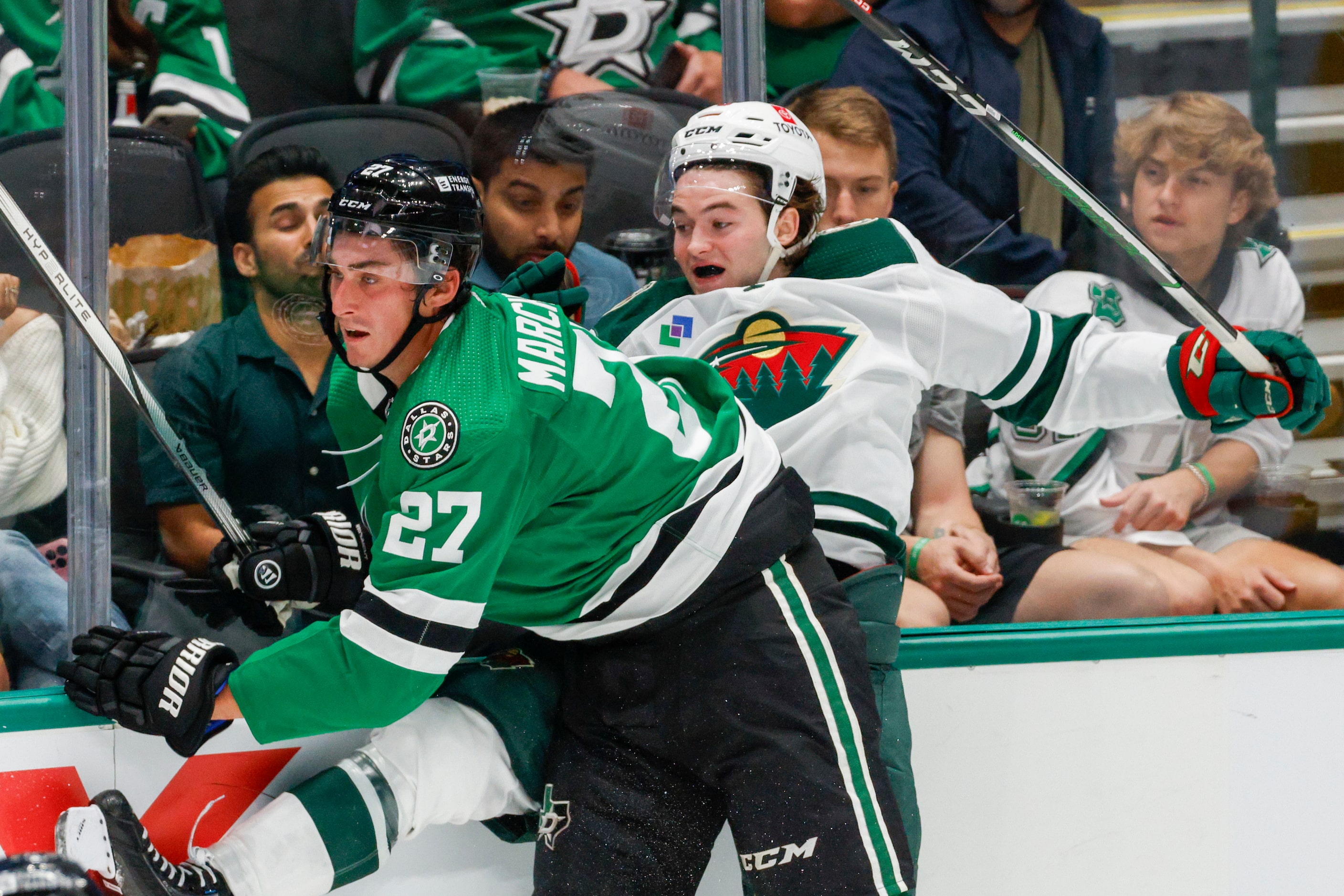 Dallas Stars left wing Mason Marchment (27) checks Minnesota Wild defenseman Kyle Masters...