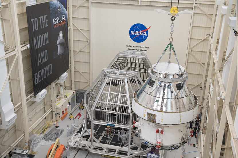 NASA’s Orion crew and service module, shown here being lifted into a thermal cage en route...