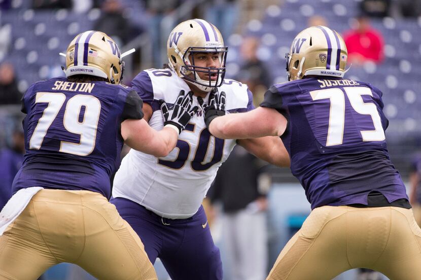 Washington defensive lineman Vita Vea (50) is blocked by Washington offensive linemen...